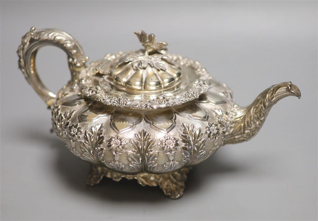 A George IV silver squat melon shaped teapot, embossed with flowers, The Barnards, London, 1829, gross 28oz.